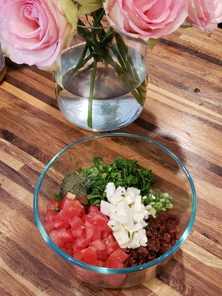 Photo showing (clockwise from top left): Chopped mint, parsley, feta, green onion, chopped sundried tomatoes and fresh tomatoes.